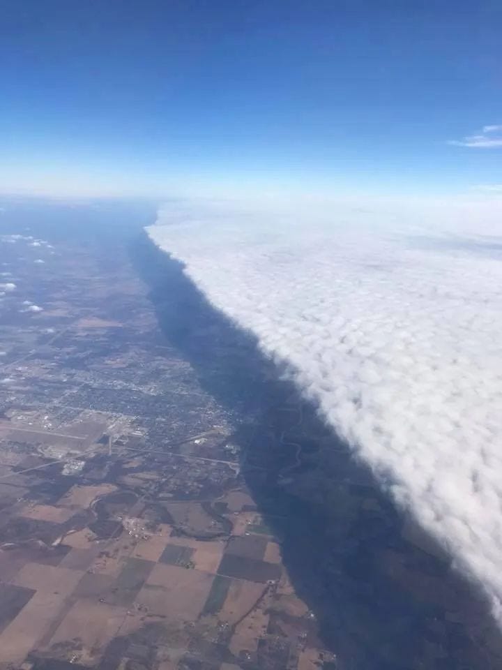 Aerial view of a cold front showcasing neatly aligned clouds.