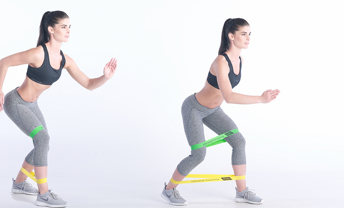 Executing banded monster walks to activate glutes