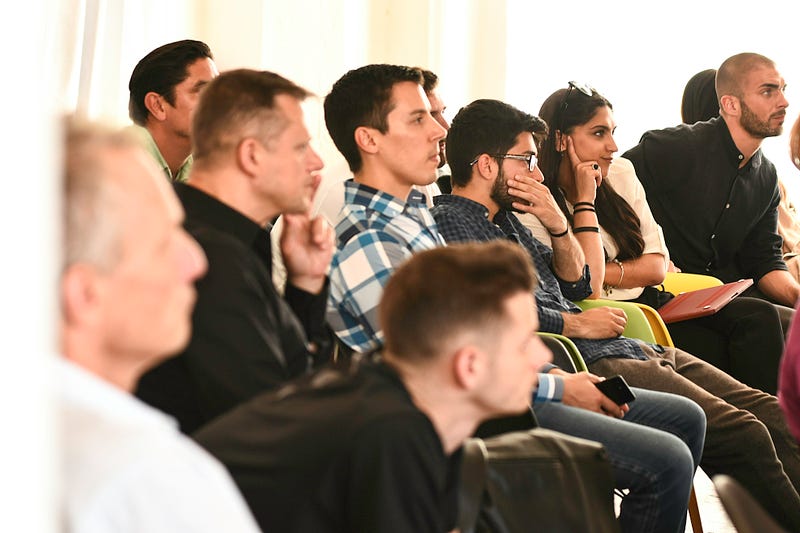 Financial seminar attendees listening intently