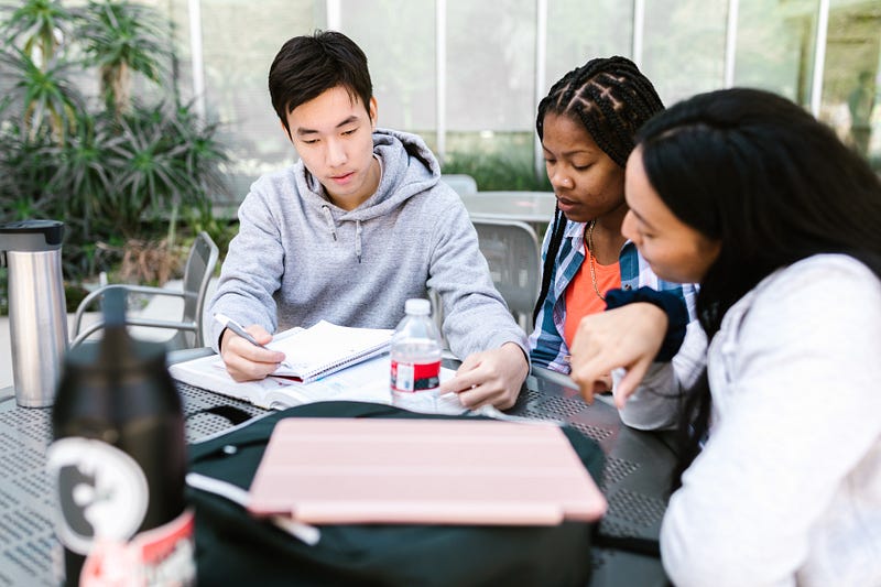 Justin engaged in group study at high school