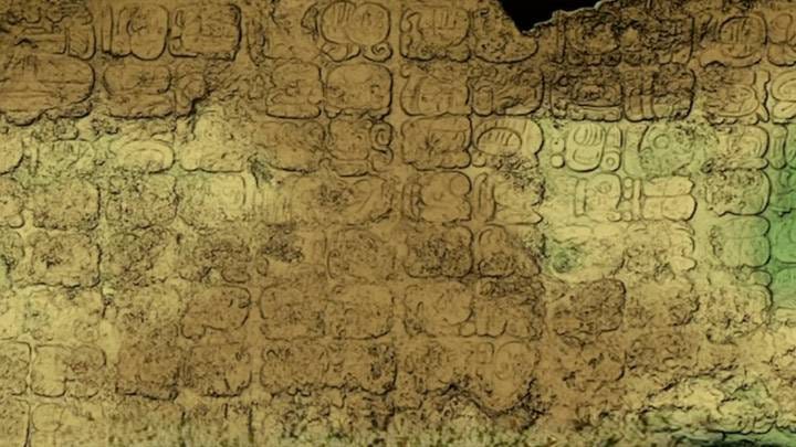 Ancient Mayan glyphs on stone panel